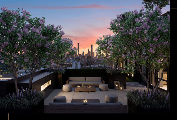 Modern outdoor rooftop terrace with couches, tables, fireplace, candles, greenery with lavender flowers and sunset city view